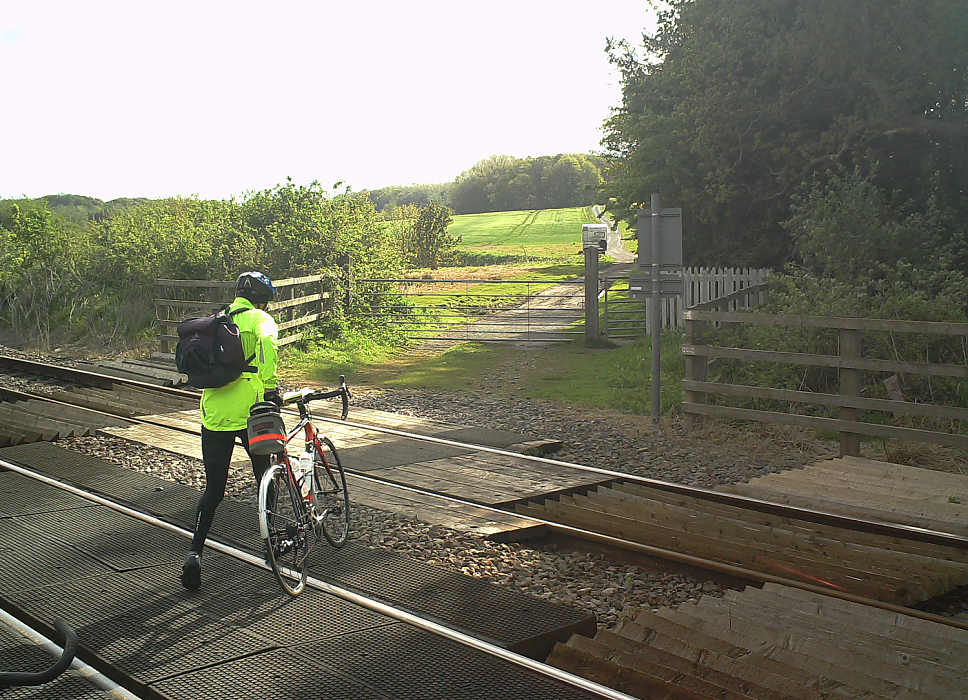 What can a bicyclist do to stay safe at train crossings?