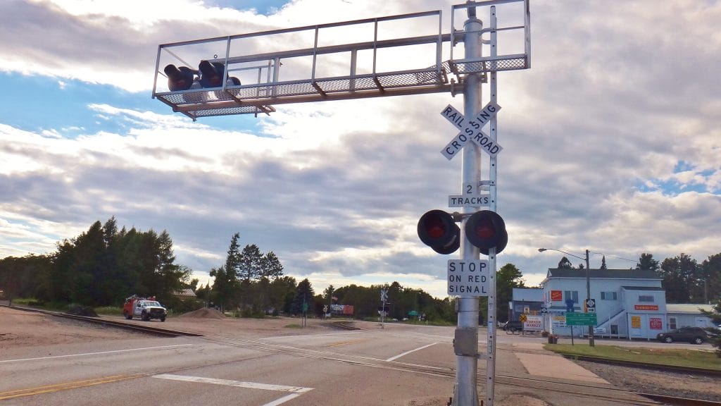 What kinds of warning devices are used at railroad crossings?