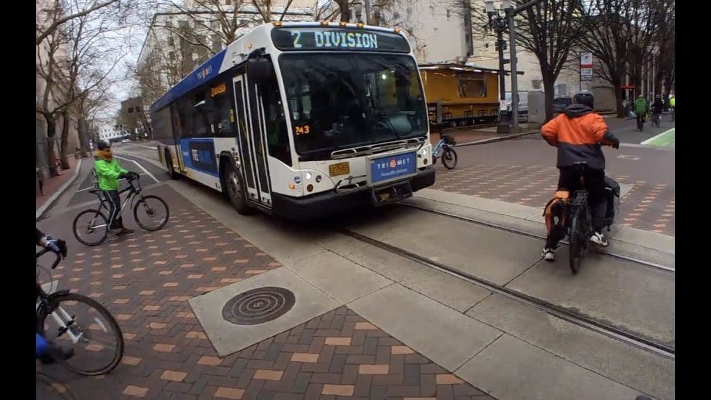 To avoid collisions with buses, bicyclists must ride with care